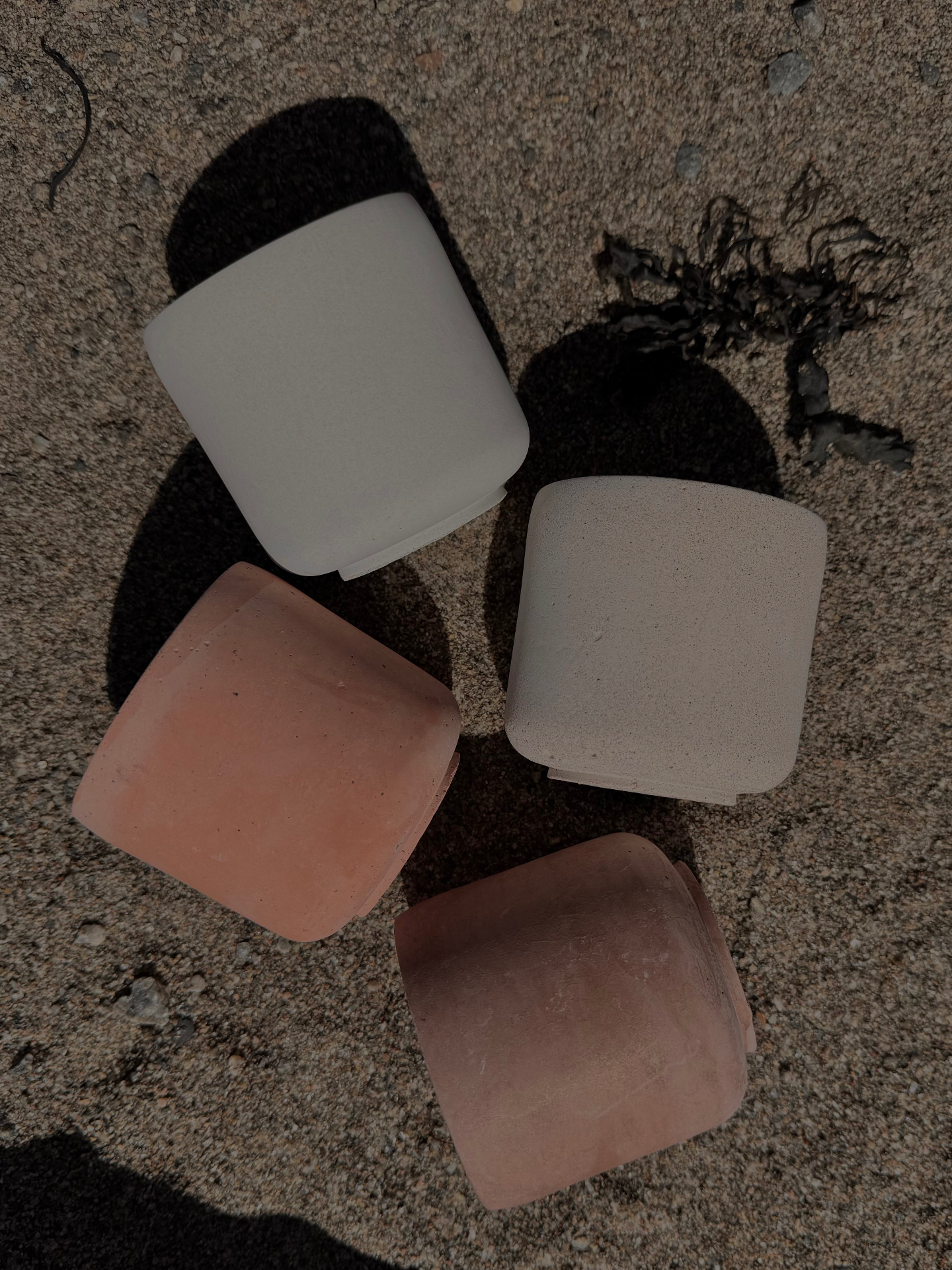The four LUĒR candles — Sol, Aura, Lune and Ember — gathered on linen